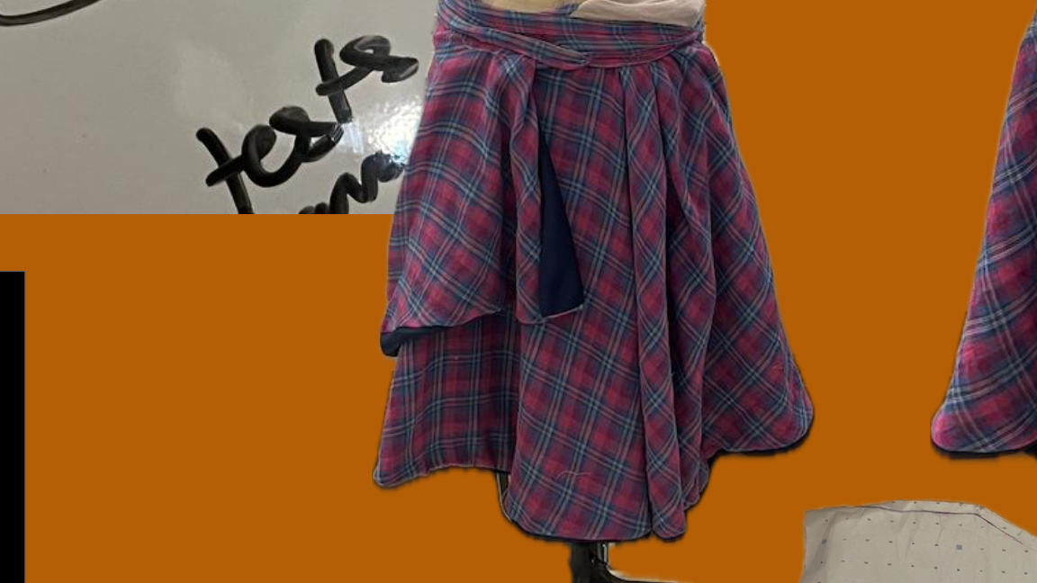 A layered waistband distorts the silhouette at the hip